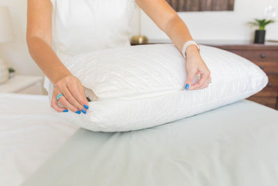 Someone pulling the zipper closed on an adjustable pillow