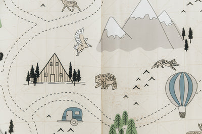 A close up on the print of an outdoor themed zipper bedding set, featuring animals, hot air balloons, mountains, cabins, and trees.