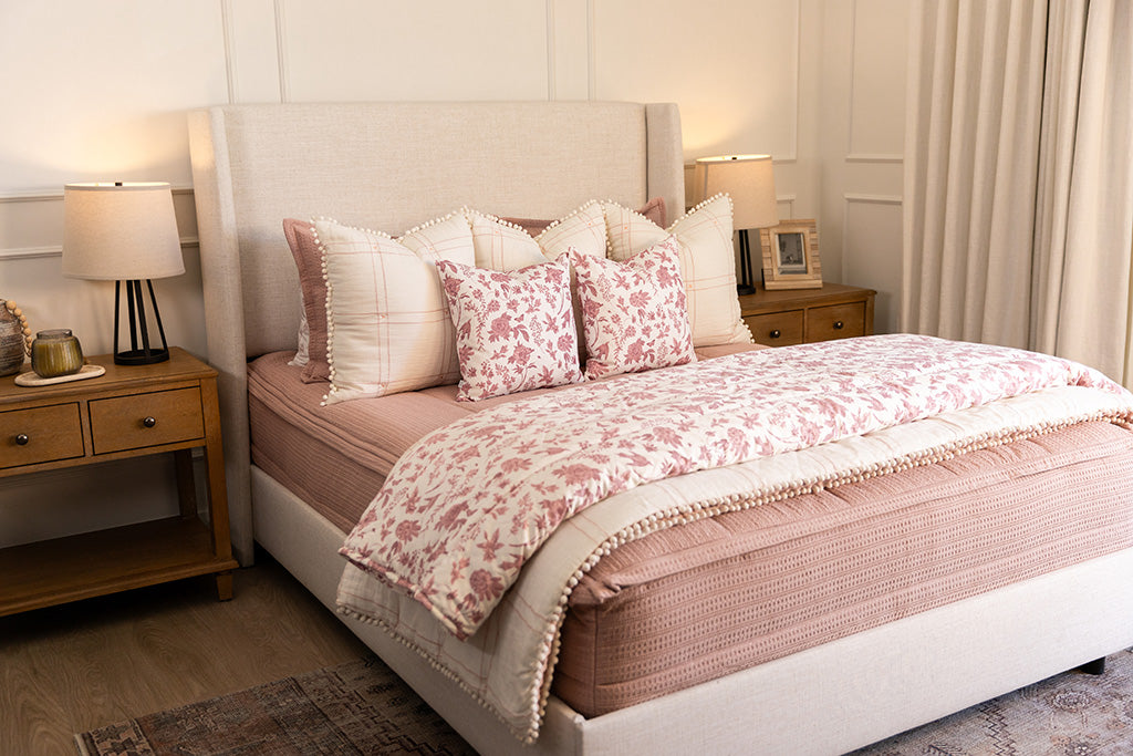A pink knitted zipper bedding with pink and white accessories.