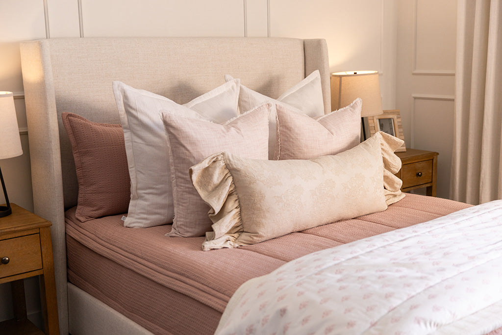 A pink knitted zipper bedding with pink and white accessories.