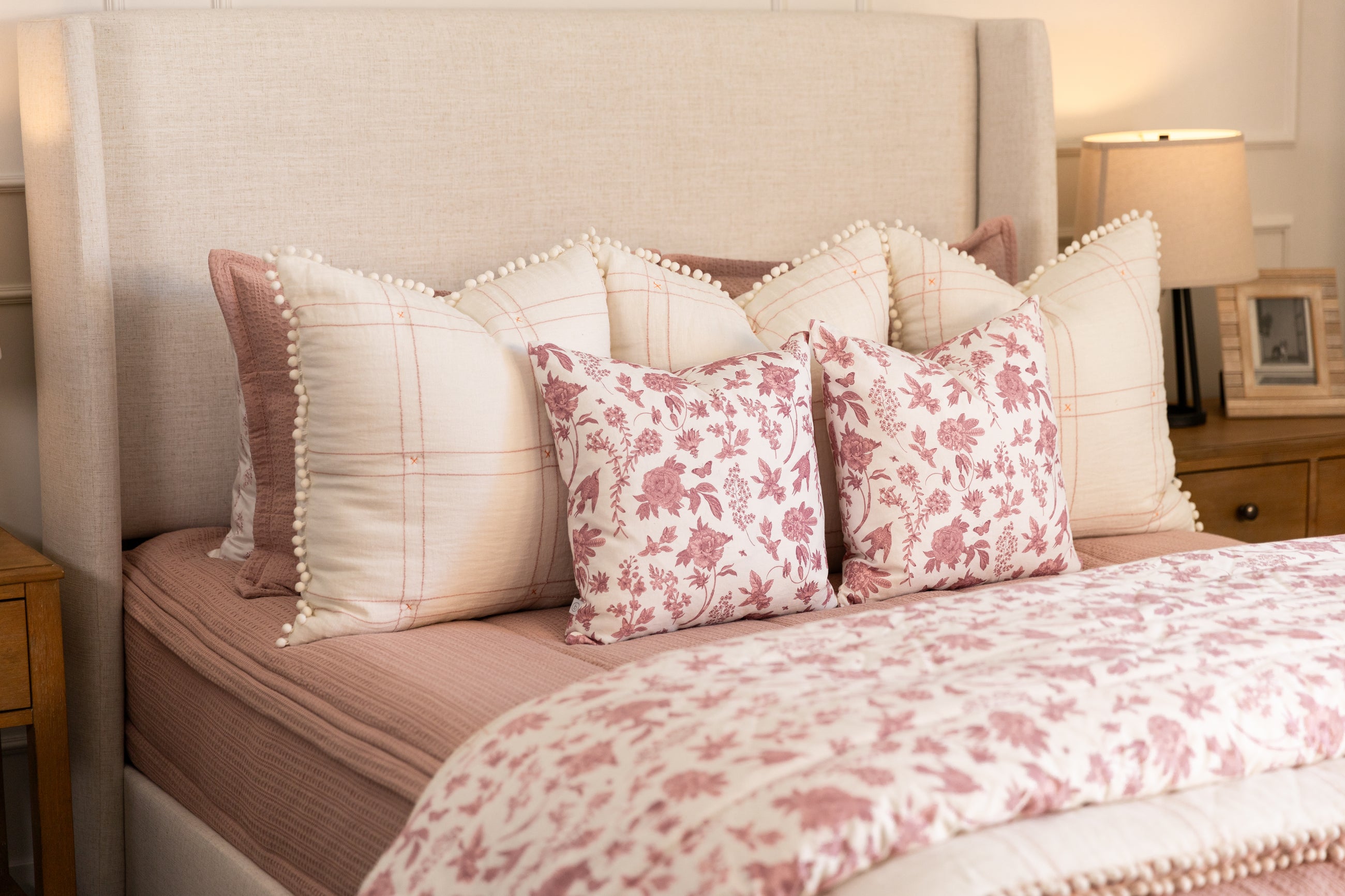 Pink zipper bedding with pink floral and white accessories