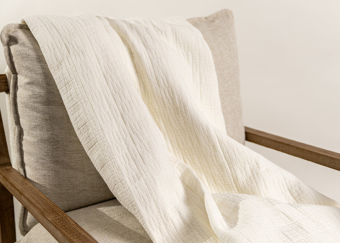 White blanket on chair on white background