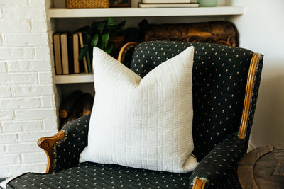 White textured cotton pillow on chair