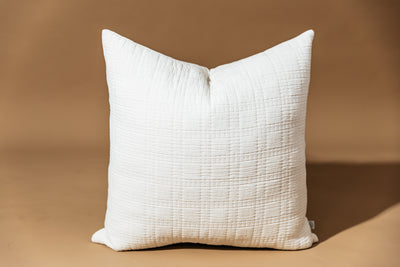 White textured cotton pillow cover on tan background