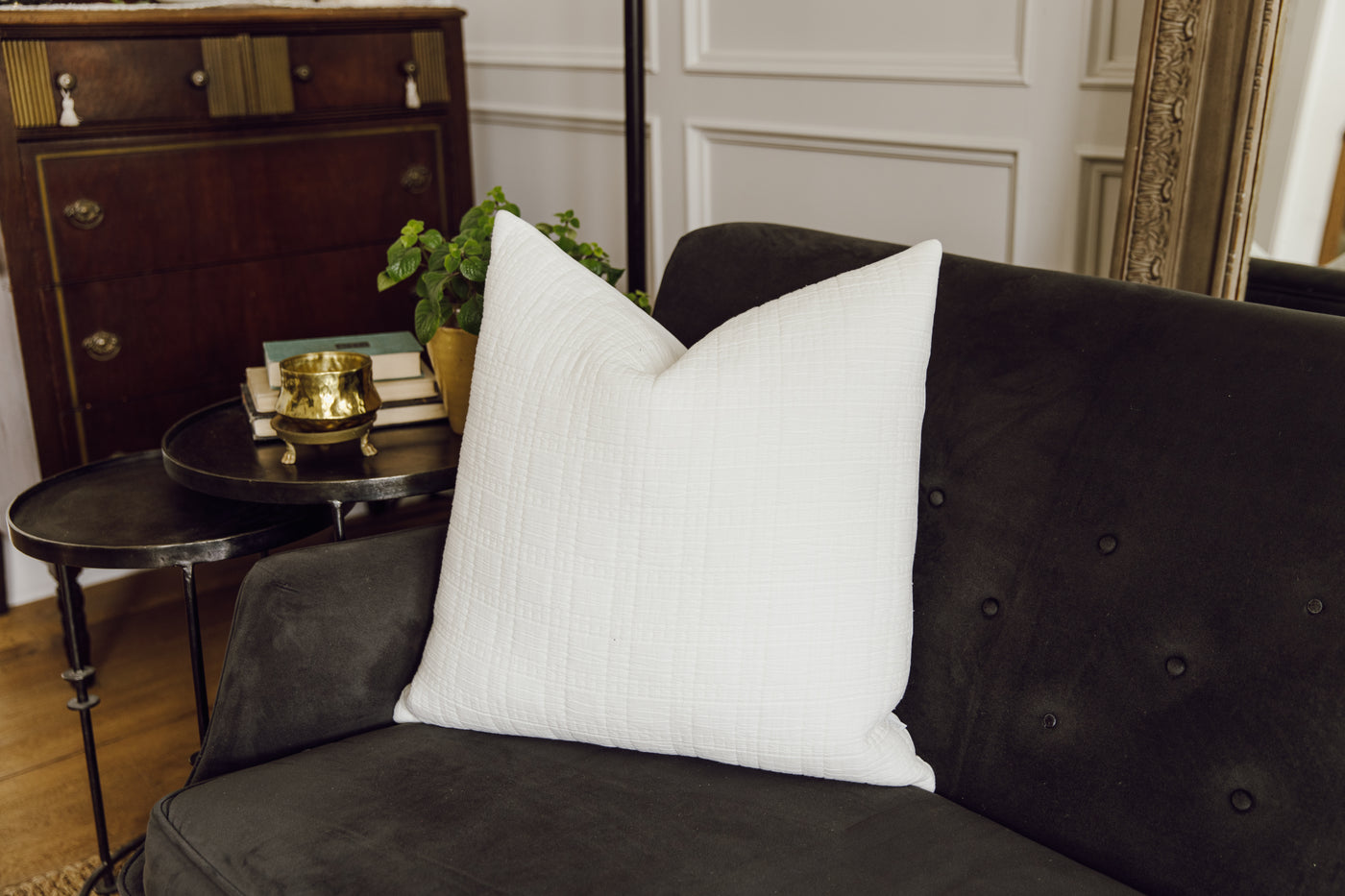 White textured cotton pillow on black couch