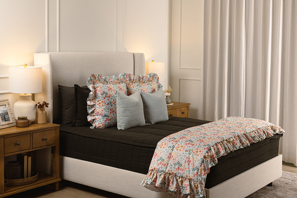 Black knit zipper bedding with floral and light blue accessories.