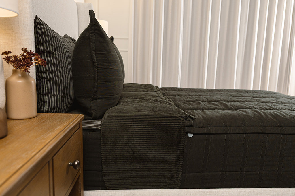 Side view of black knit zipper bedding.