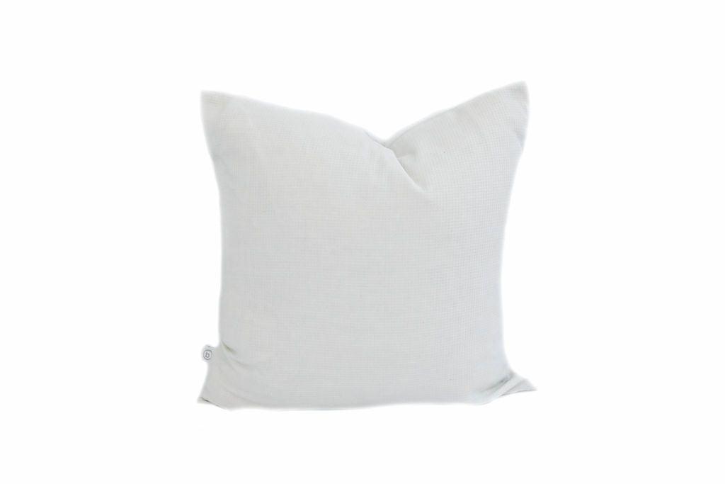 A light gray waffle textured pillow on a white background.