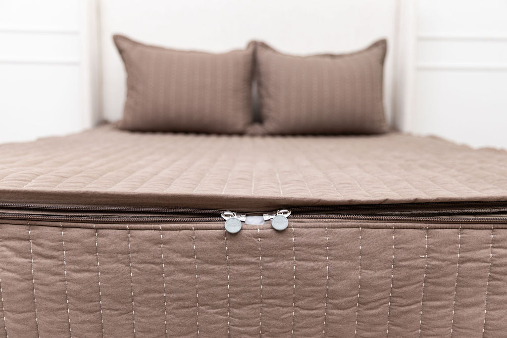 the foot of a bed made with zipper bedding, a close up on the zipper features