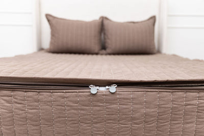 the foot of a bed made with zipper bedding, a close up on the zipper features