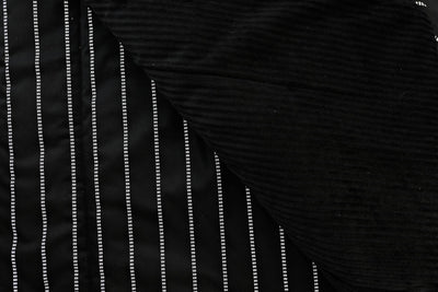 black blanket with dotted white stripes and soft black minky interior