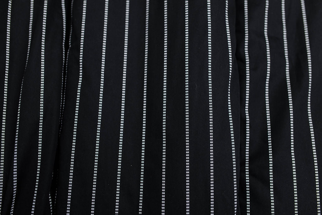 A close up view of the exterior of a black and white striped blanket