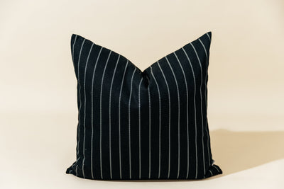 A black striped euro pillow arranged on a cream background.