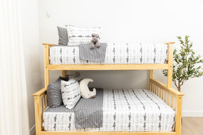 A bunk bed where both bunks are made with shark kids zipper bedding