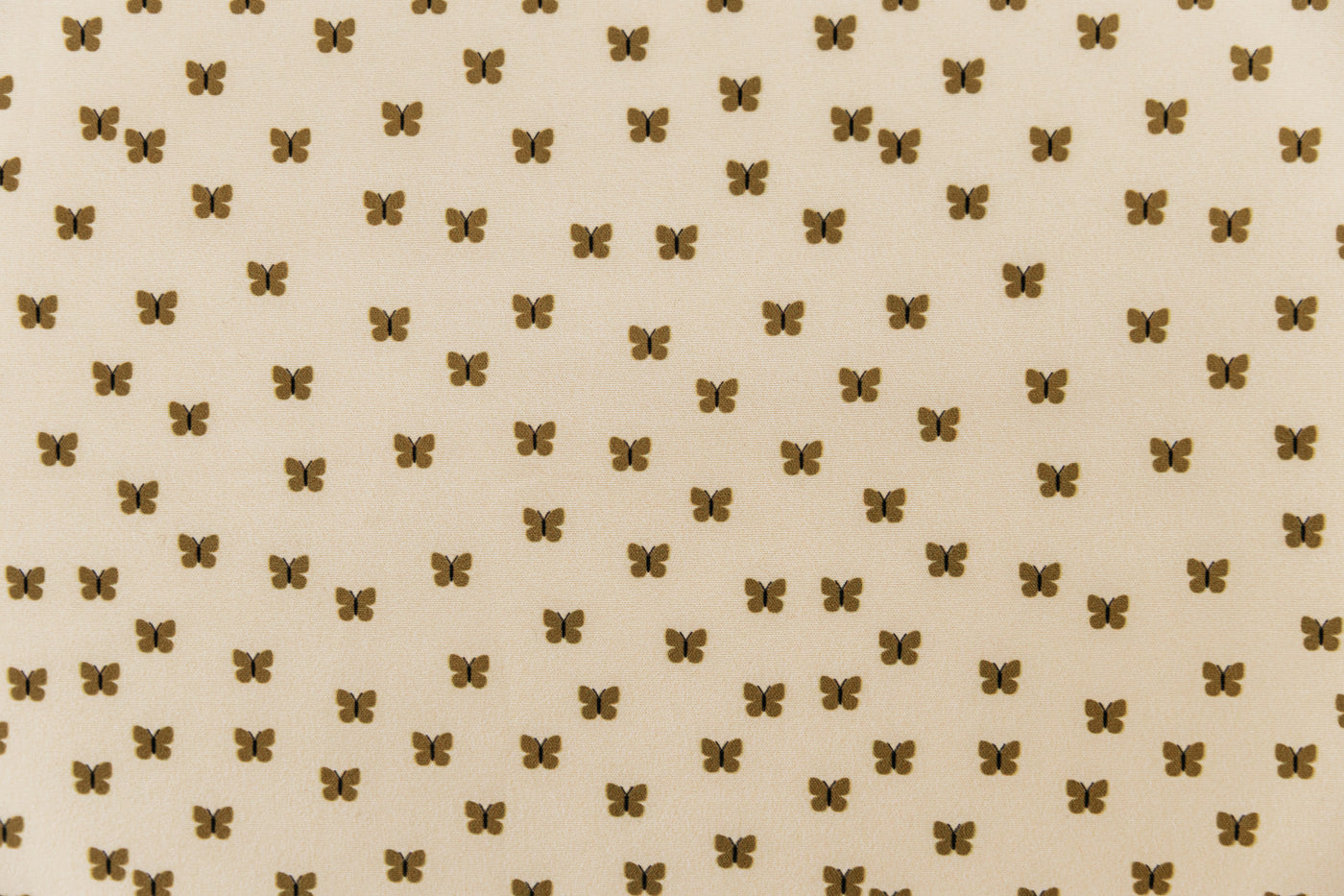 A close up of the interior of a set of butterfly zipper bedding, showcasing the small, neutral butterfly print.
