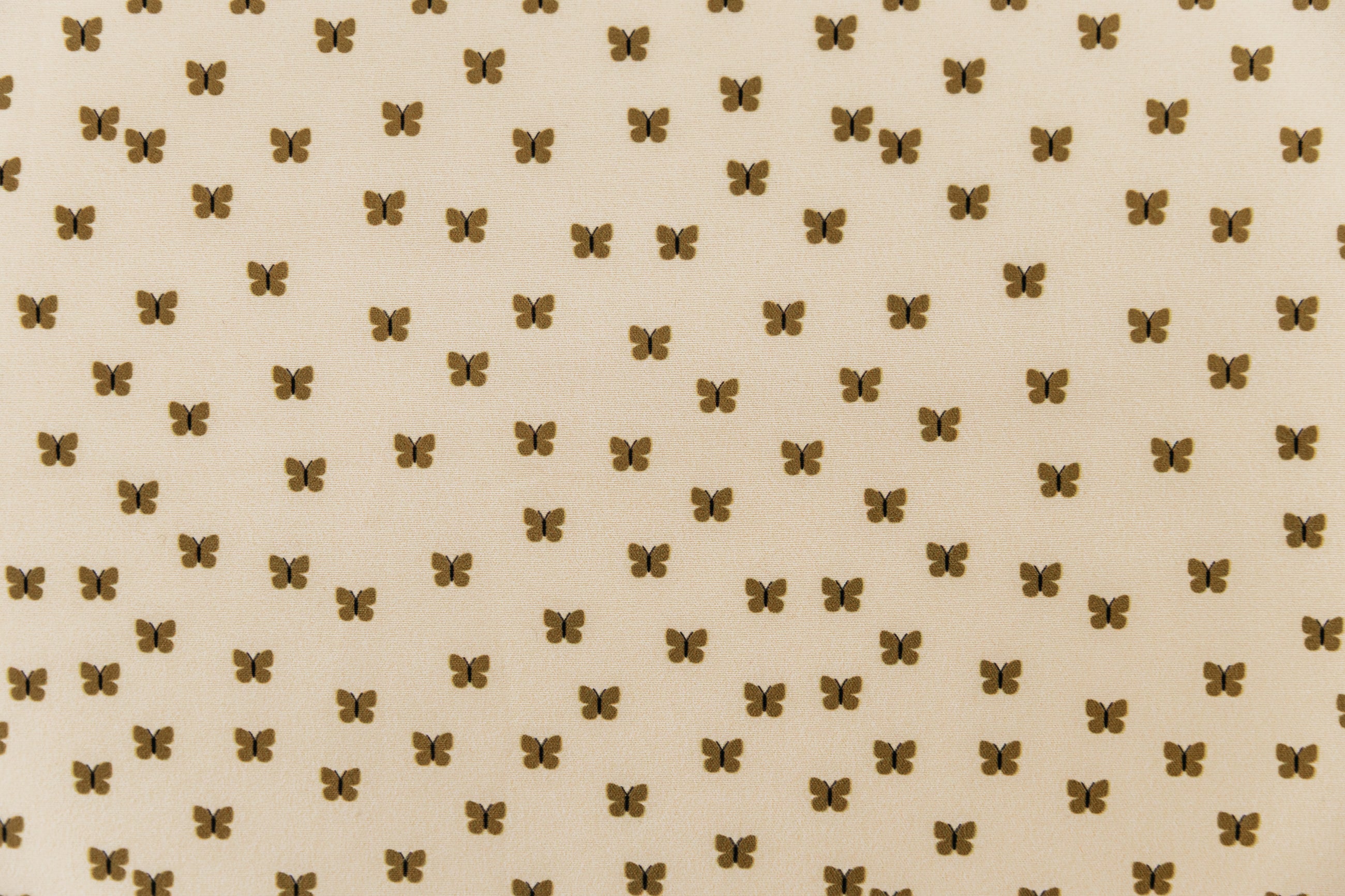A close up of the interior of a set of butterfly zipper bedding, showcasing the small, neutral butterfly print.