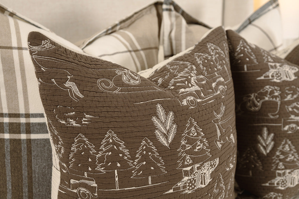 Brown and cream quilted holiday themed pillows.