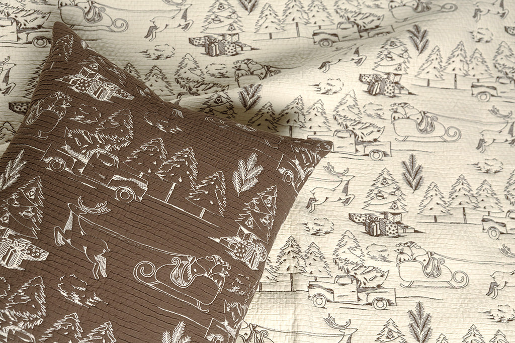 Brown and cream quilted holiday themed pillow and blanket.