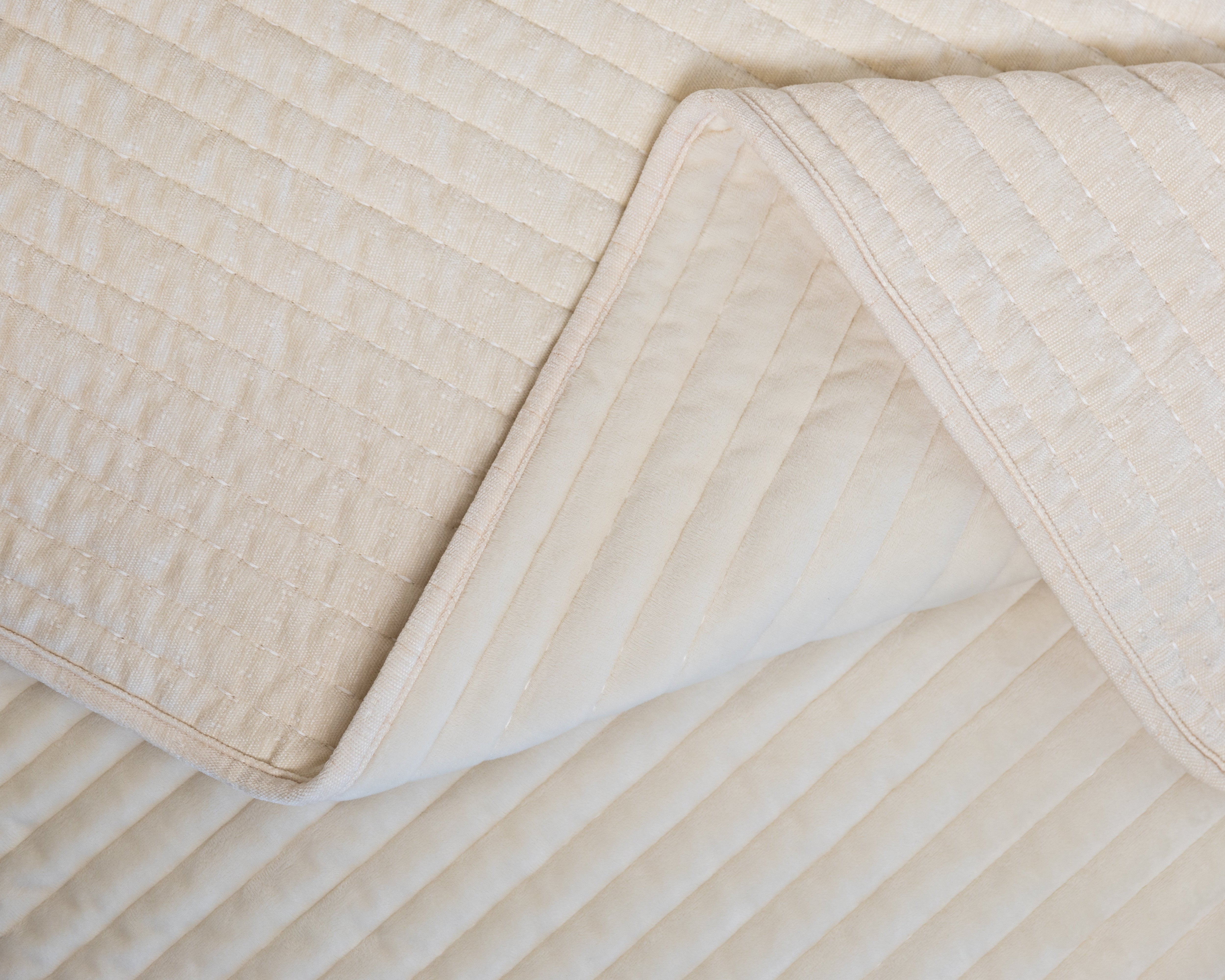 Photo with both textured and minky sides of cream blanket