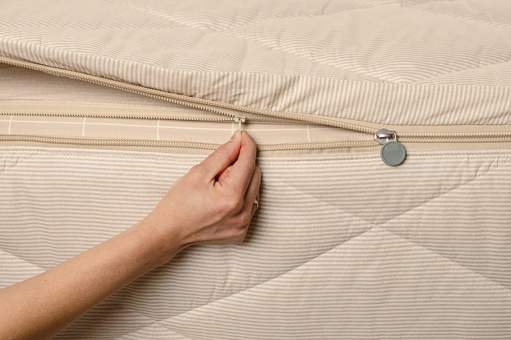 Close up of zipping layers in tan stripe zipper bedding.