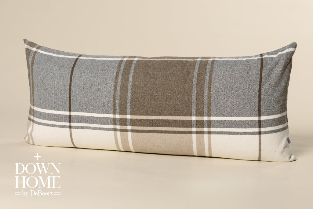 Brown, gray, and white xl lumbar pillow on a cream paper backdrop.