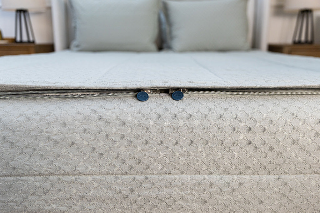 End of bed showing double zippers on sage honeycomb zipper bedding.