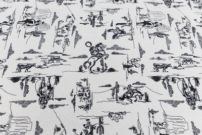 A close up view of a white and black western printed blanket. 