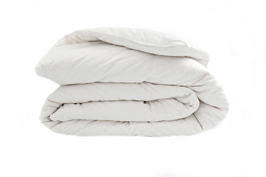 A side few of a white down duvet insert folded. 