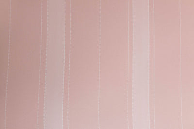 A close up view of a pink striped interior lining of a pink zipper bedding.