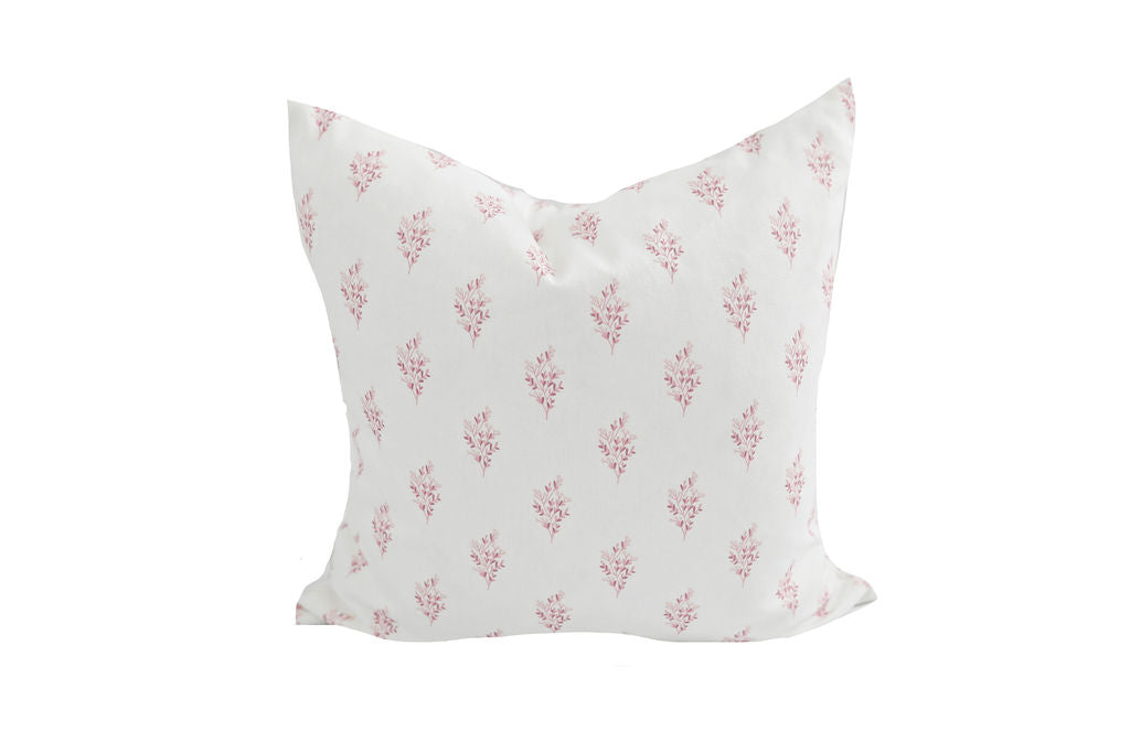 white pillow with pink floral pattern
