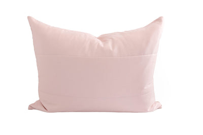 A pink pillow sham on a white background.