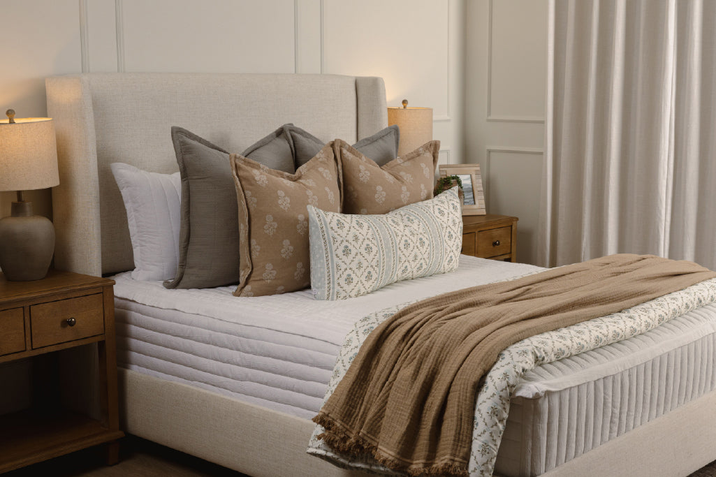 White stripe quilt zipper bedding with tan, gray, and floral accessories.