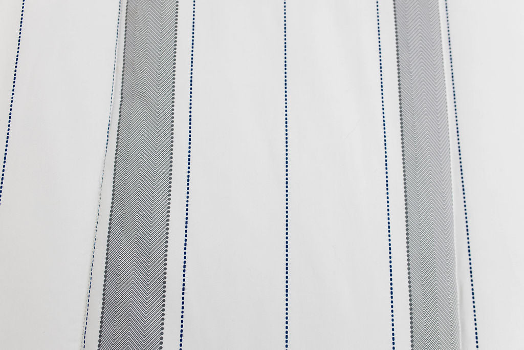 A close up view of a gray and white striped blanket. 