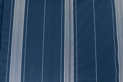 A close up detailed view of the gray striped interior of a navy blue zipper bedding.