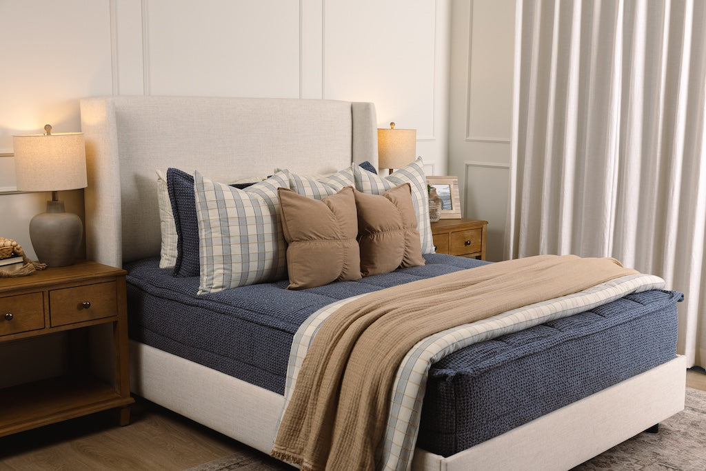 Soft, blue waffle texture zipper bedding with tan and plaid accessories.