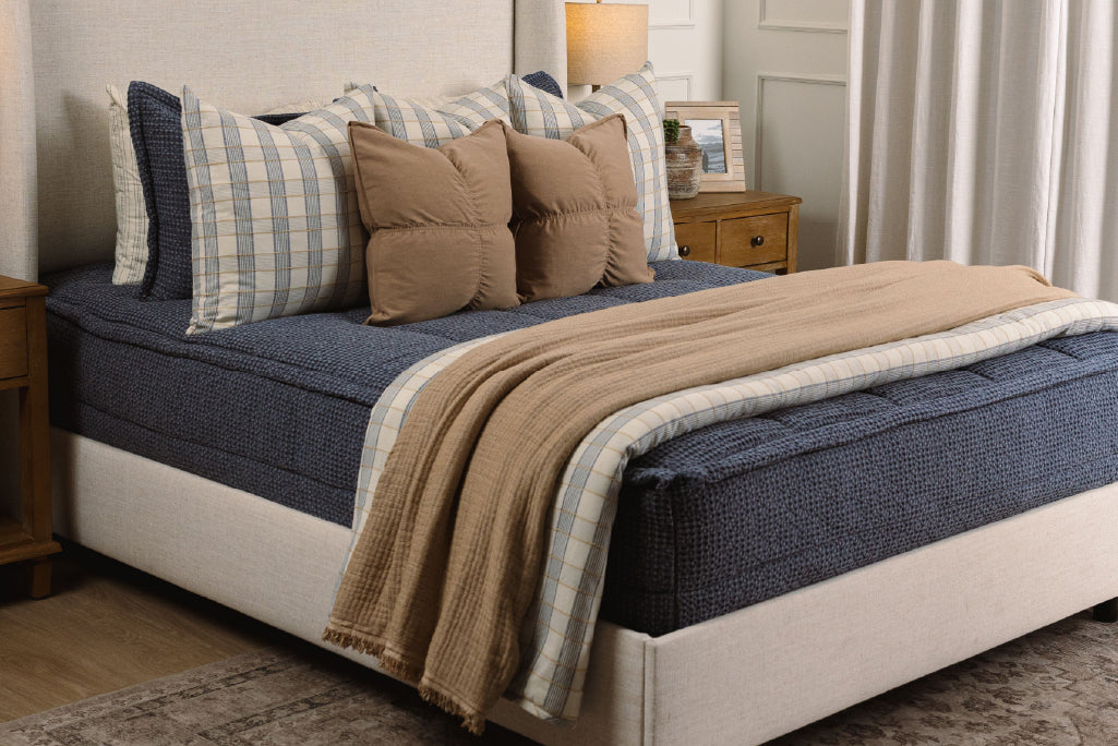 Soft, blue waffle texture zipper bedding with tan and plaid accessories.