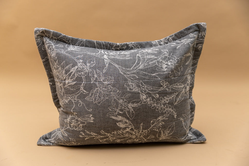 Gray and cream sketched floral sham pillow on tan background.