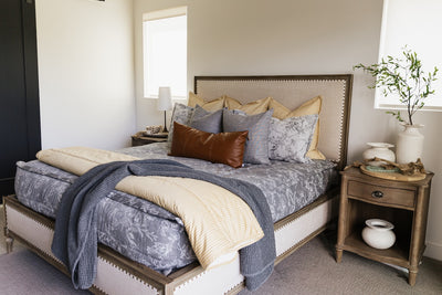 A cream sketched floral pattern with a charcoal base zipper bedding with gray, yellow and rustic accessories.