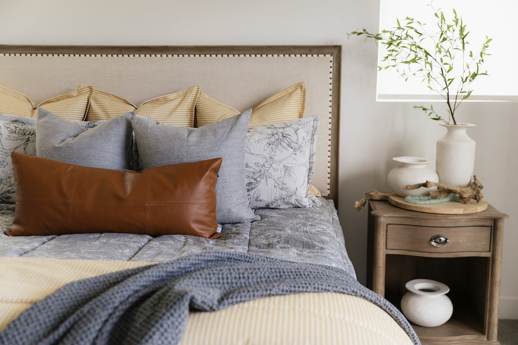 A cream sketched floral pattern with a charcoal base zipper bedding with gray, yellow and rustic accessories.