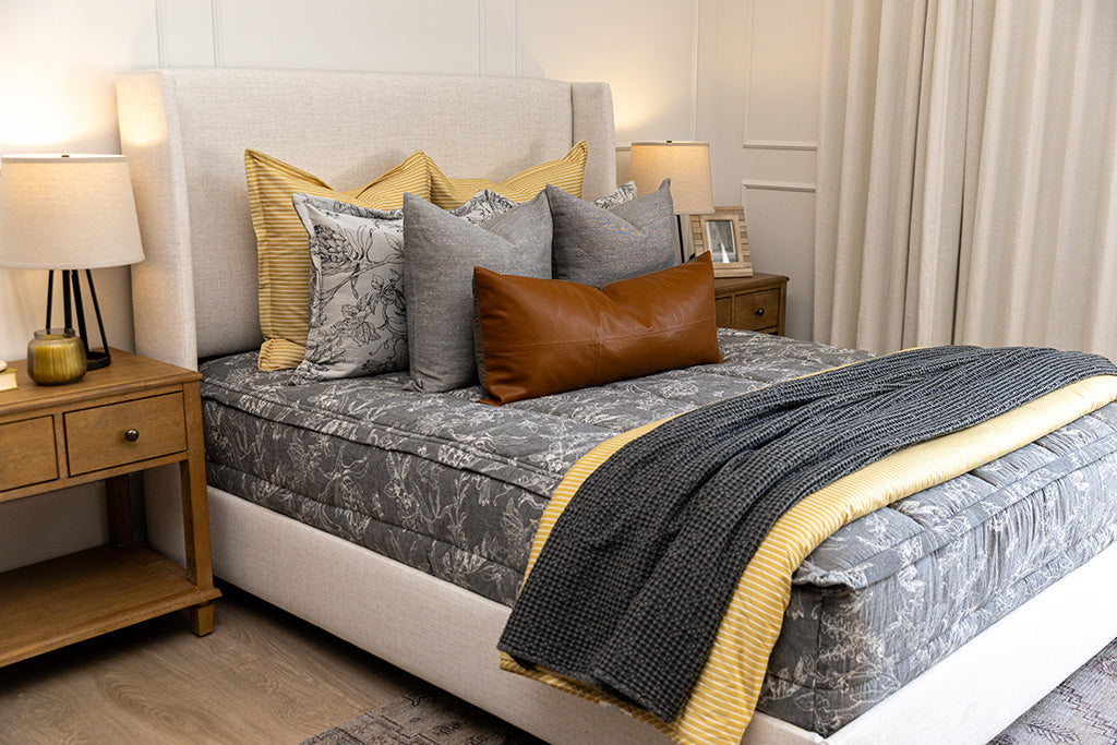 A cream sketched floral pattern with a charcoal base zipper bedding with gray, yellow and rustic accessories.