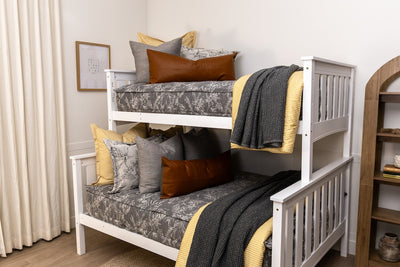 A bunk bed made with sketched floral zipper bedding with gray, yellow, and rustic accessories.