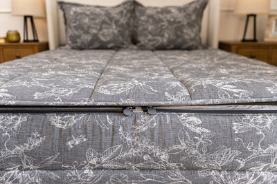 End of bed showing double zippers on sketched floral zipper bedding.