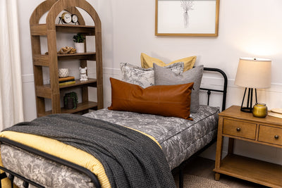 Twin bed with sketched floral zipper bedding with gray, yellow, and rustic accessories.