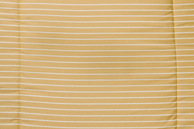Yellow and cream stripe pattern on blanket.