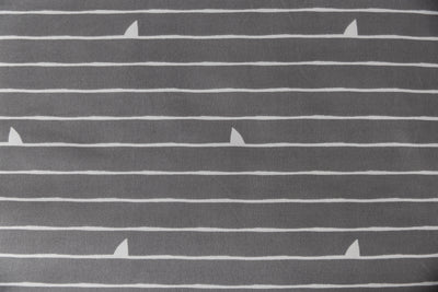 A close up of the interior print on a set of shark kids zipper bedding