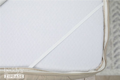 A close up on the elastic strap that runs across each corner of a mattress when there is a Beddy's ZIpBase zipper bedding set on it