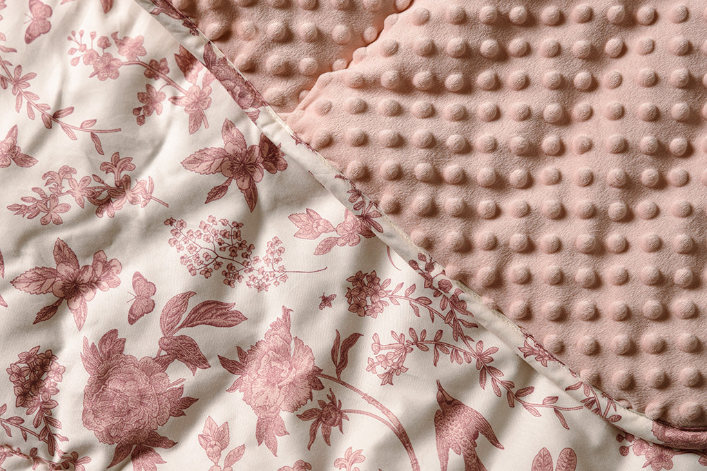 A pink and white, floral and minky blanket.