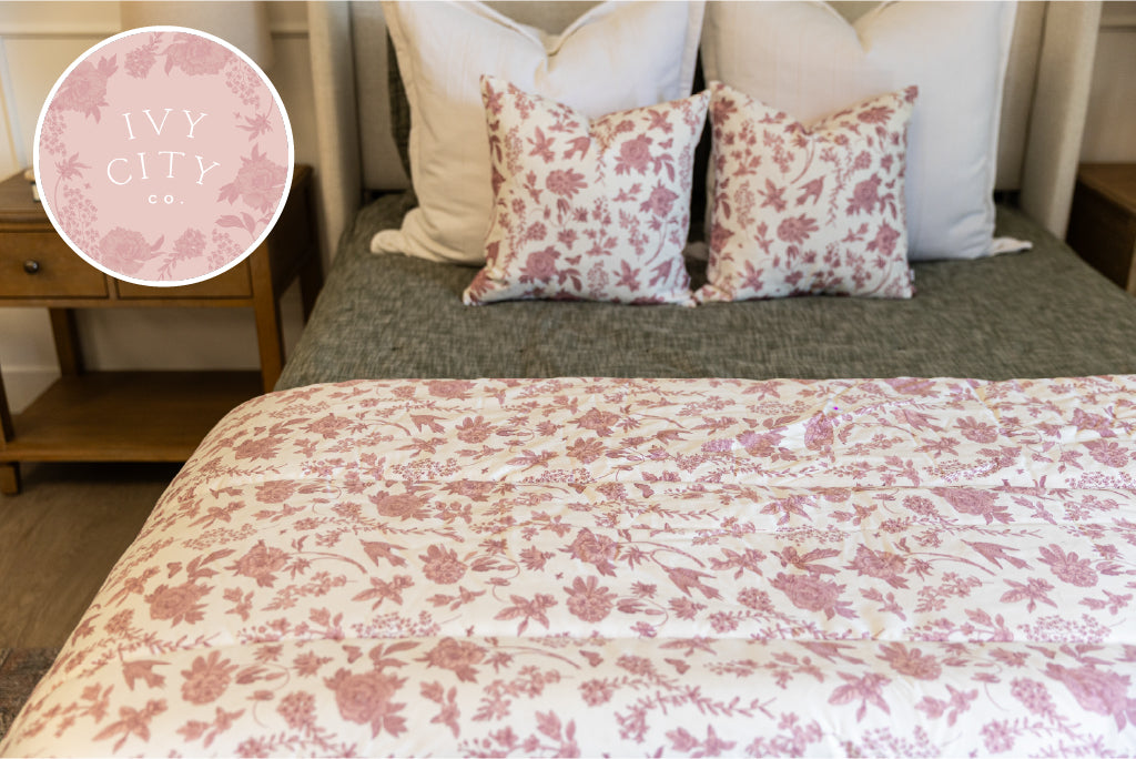 Pink and White floral blanket on green zipper bedding with white and pink accessories