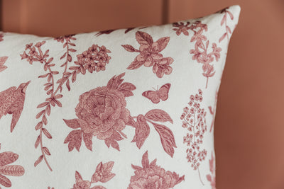 Corner shot of white and floral patterned pillow