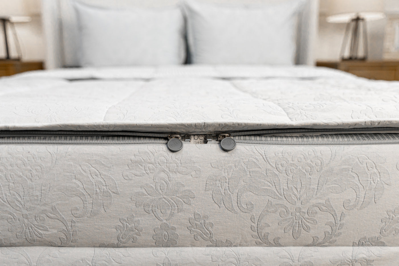 End of bed showing double zippers on blue floral zipper bedding